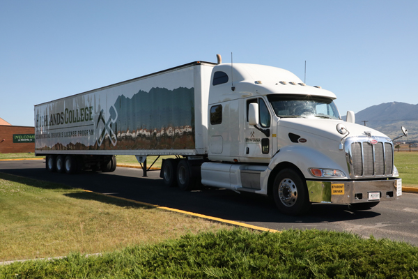 Semi truck with 'Highlands College' branding.