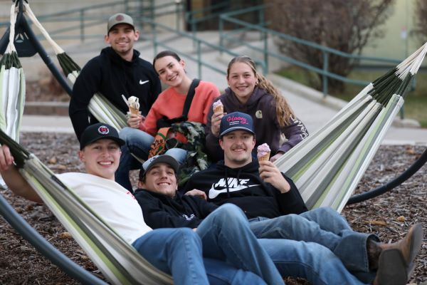 Students lounge in hammocks and eat ice cream during M Days.