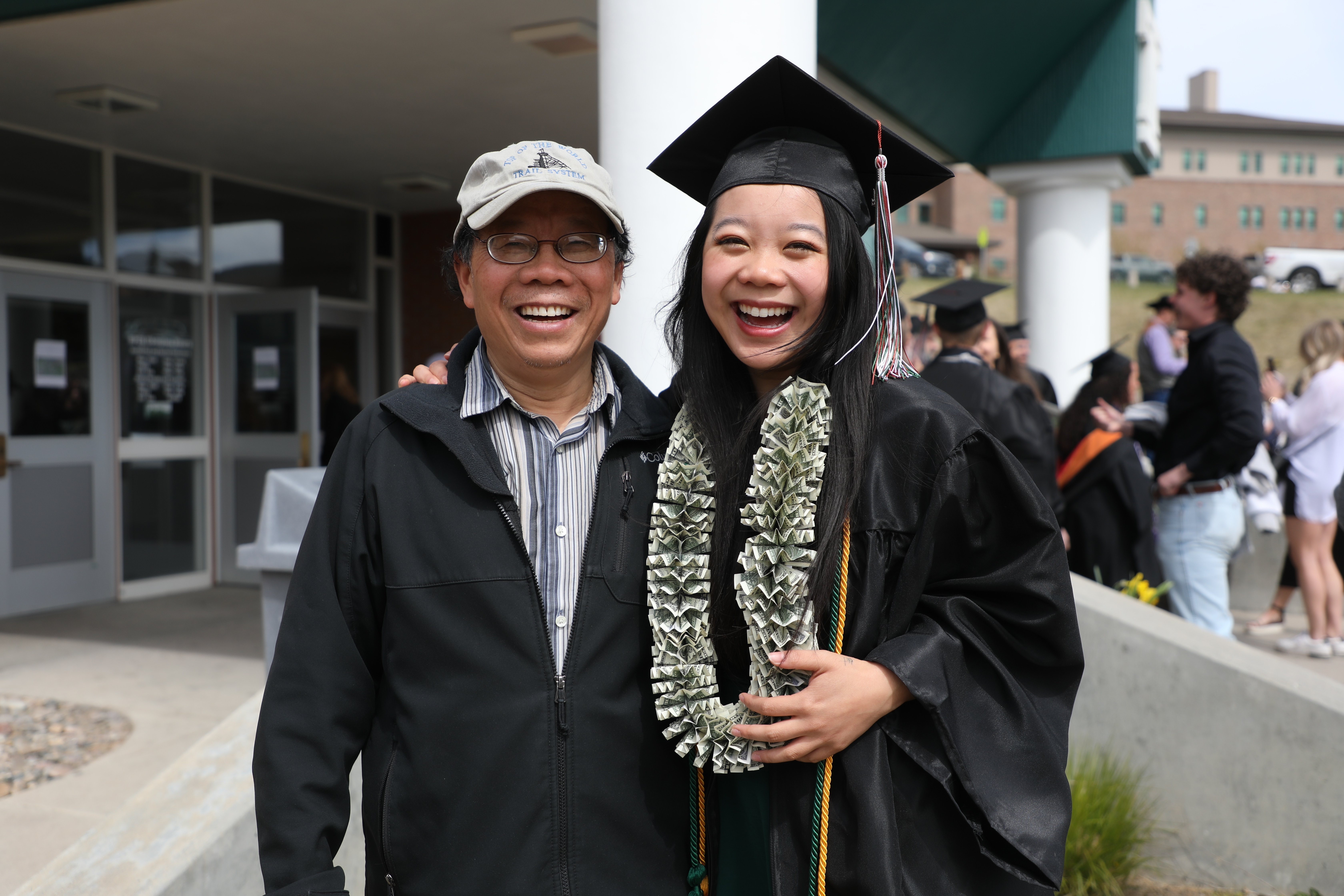 Students pose for a photo in their caps and gowns