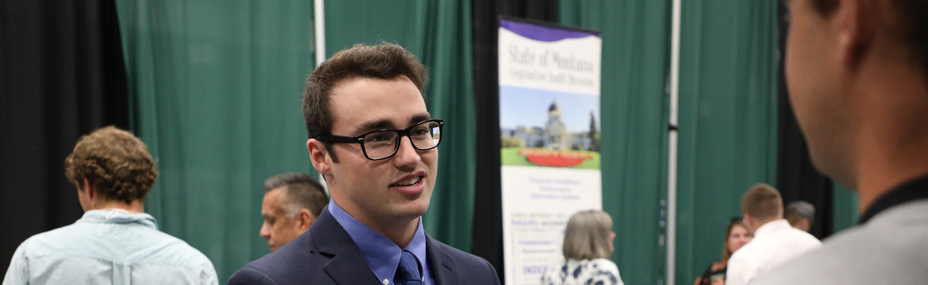 A student wearing a suit and a tie