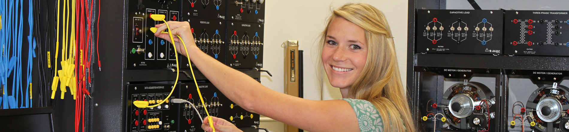 Electrical engineering student using lab equipment