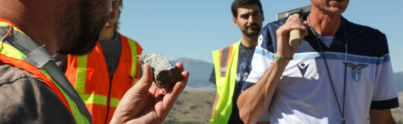 Student inspecting a rock