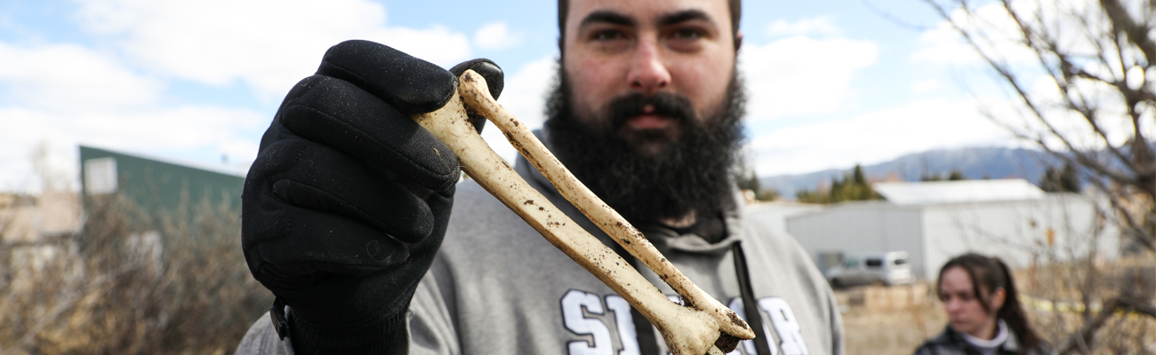 Student holding a bone