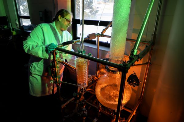 A researcher stands over a bubbling tower
