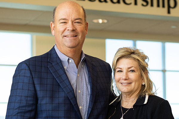 Ryan and Lisa Lance in front of the Lance Leadership Hall at Montana Tech