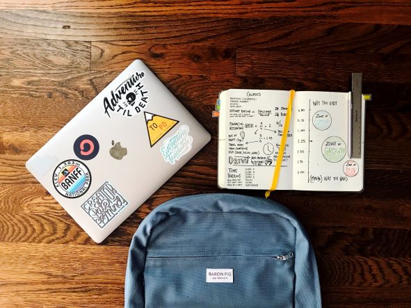 image of backpack and paper notepad