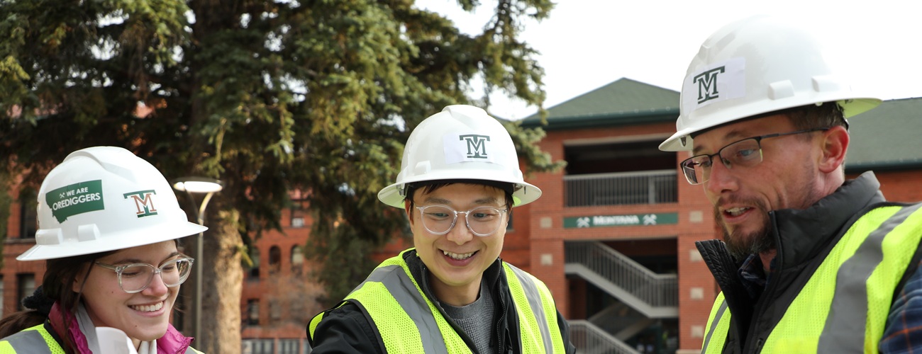 Construction management students building a house