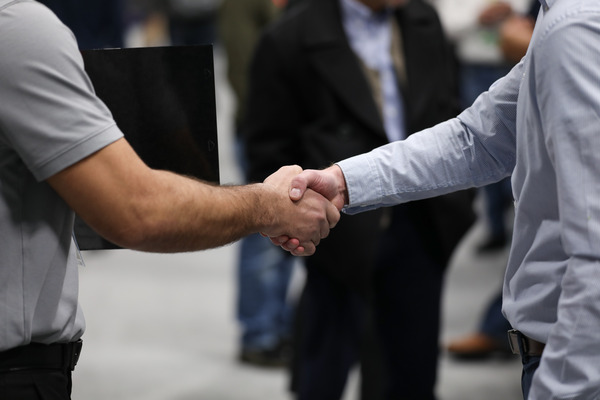 A student and an employer shaking hands