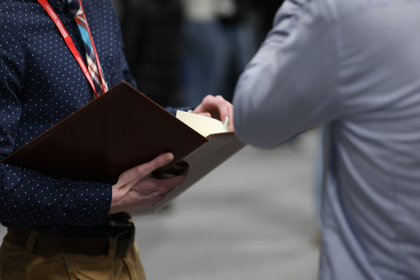Student holding padfolio.
