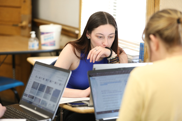 Two female students doing homework in the classroom