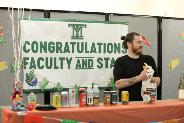 Faculty/Staff Awards Ceremony Banner behind community member