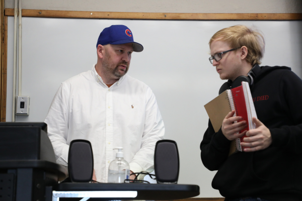Faculty member talking to student after class.
