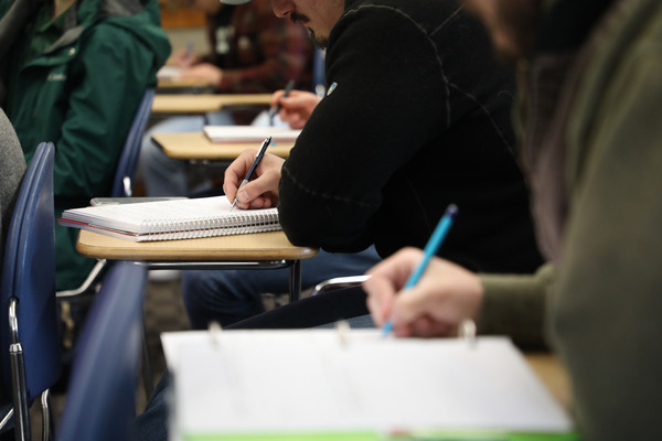 Students taking notes in class.