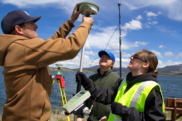 Geophysical Engineering graduate students setting up a GPS station on Georgetown Lake