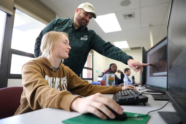 Student and professor in a classroom.