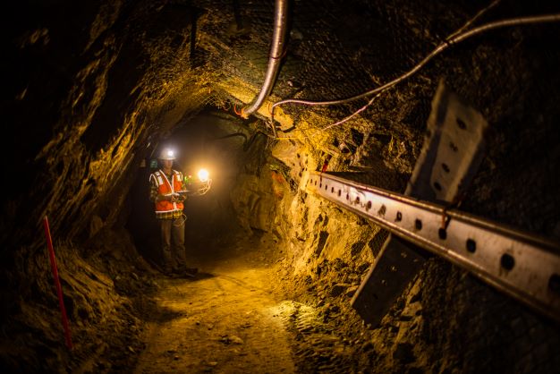 A person flying a drone in an underground mine.