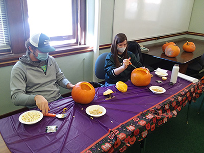 honors students carving pumpkins