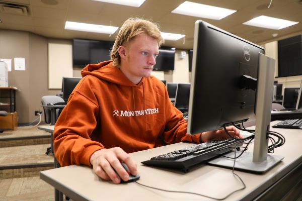 !Andrew Daigle works at a computer