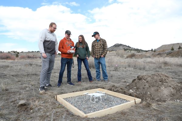 Montana Tech students with a drone on the launchpad