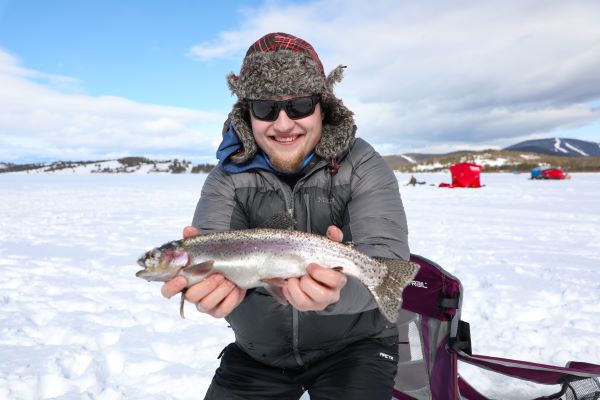 A student shows off a trout