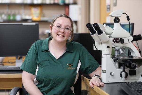 Baylie Philips with a microscope