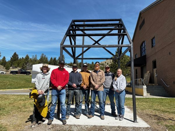 students stand with the solar demonstration area