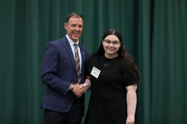 Lily Brouch shakes the hand of Chancellor Les Cook