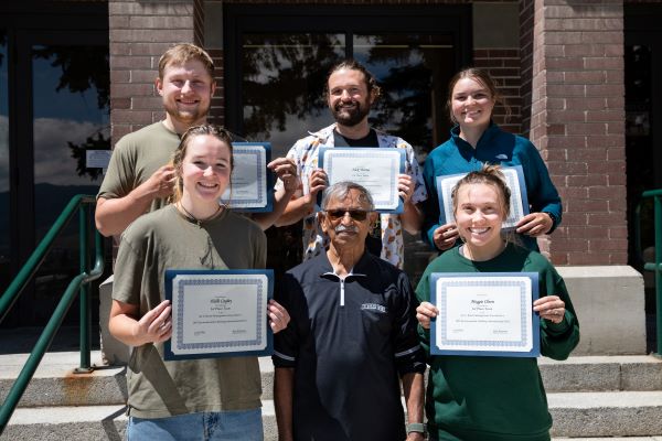 !Five students and professor Kumar Ganesan hold certificates and pose for a photo