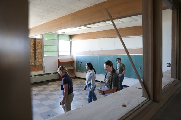 Four students examine Blaine School