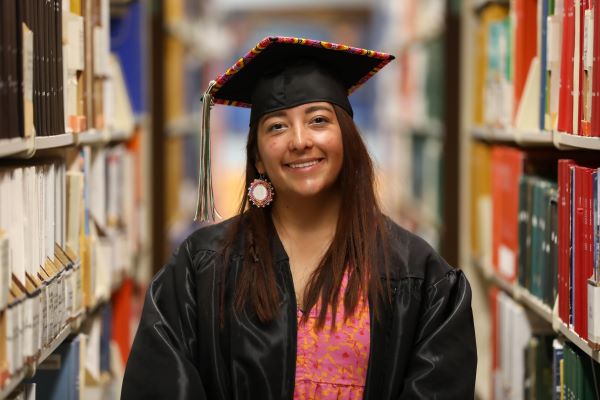 !Rylee Mitchell poses for a photo in her beaded cap and gown