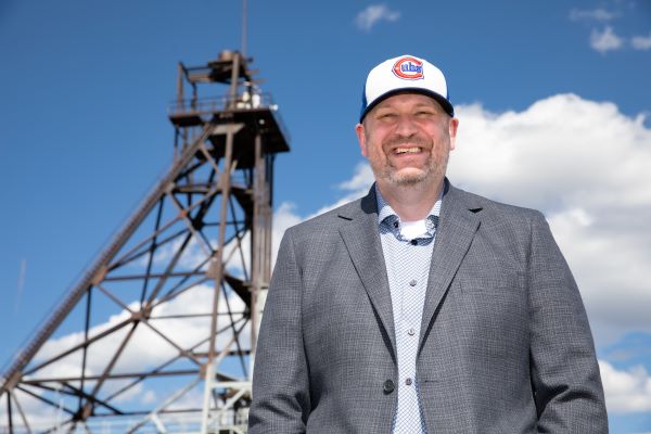 Dr. Richard LaDouceur in front of a headframe in Butte
