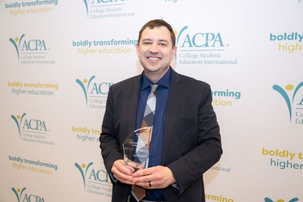 Joe Cooper poses with an award