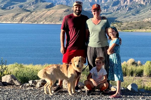 Chris Dienes poses at the lake with three family members