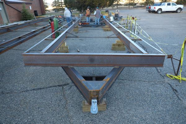 A welding student works on a trailer