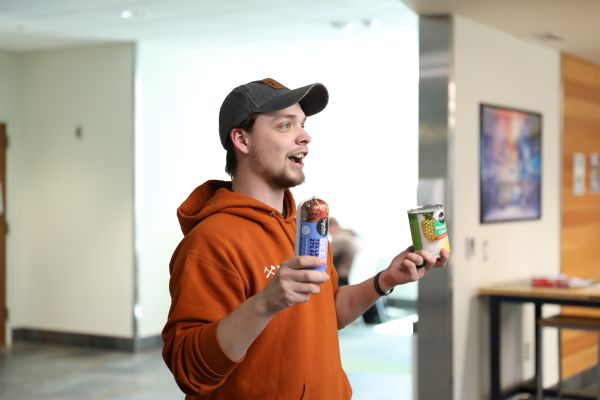 Quinn Cox holds challenge ingredients up of ground beef and pineapple