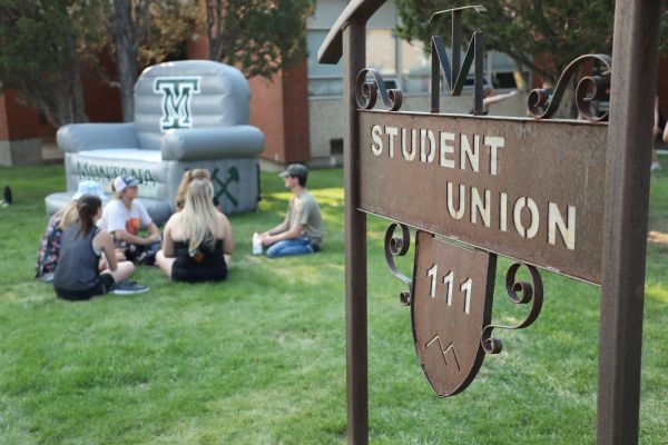 !Students lounge outside the student union building