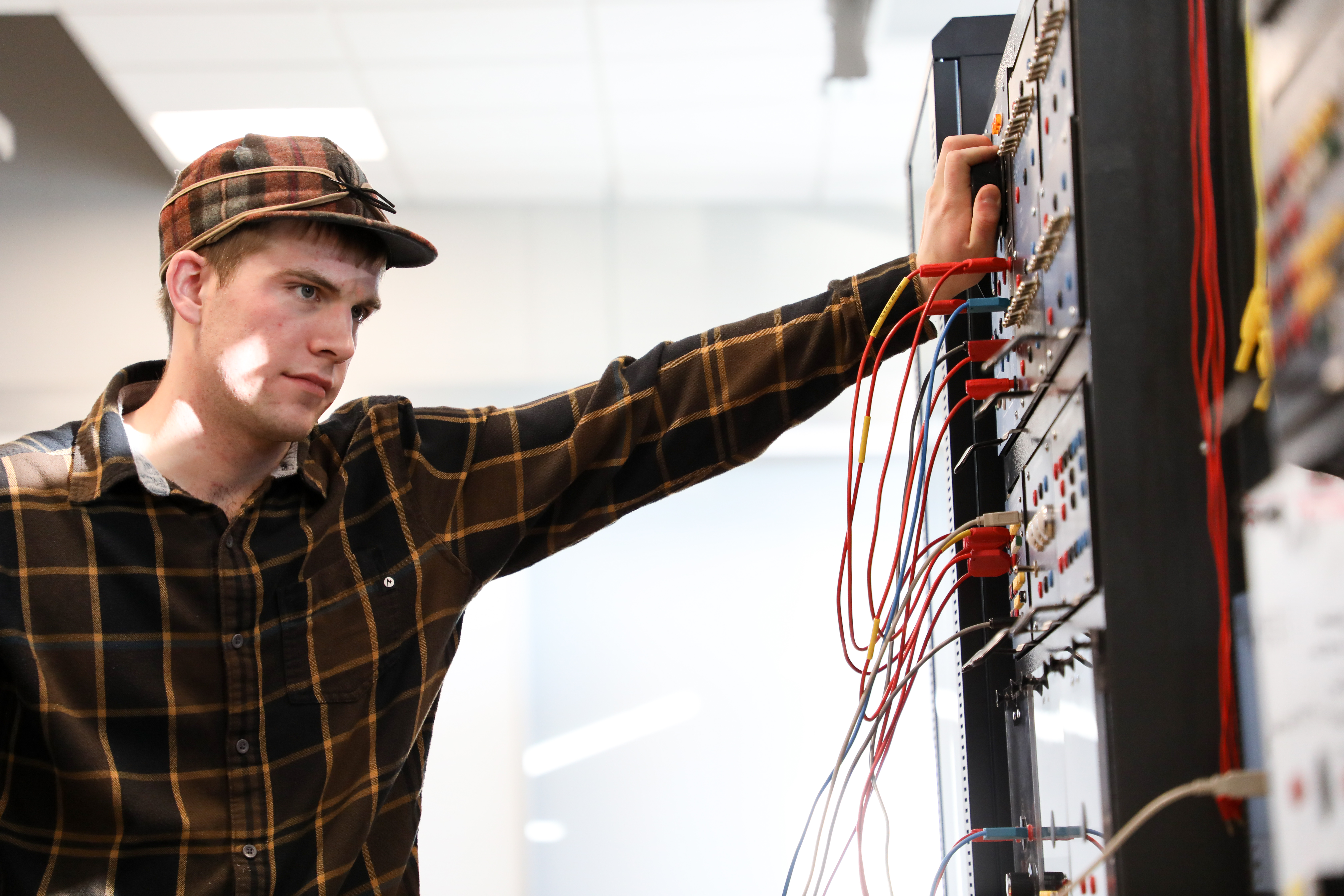 !An electrical engineering student works with wires