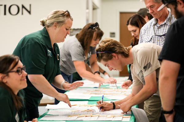 !Students sign in at an event