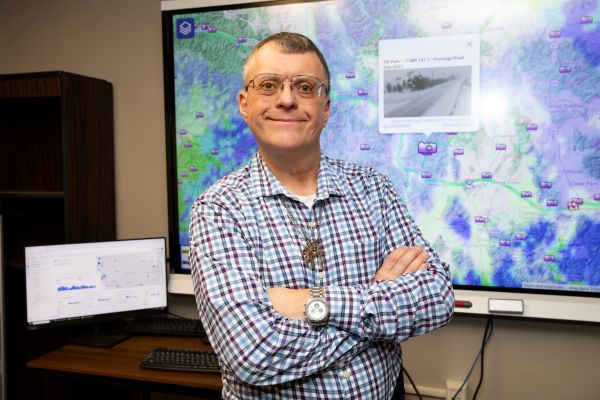 Doug Galarus in front of smartboard with OSS website behind him