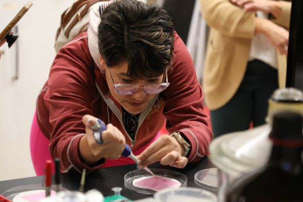 !student works in lab with pipet