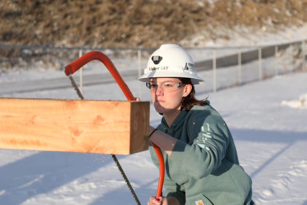 A student practices Swede saw