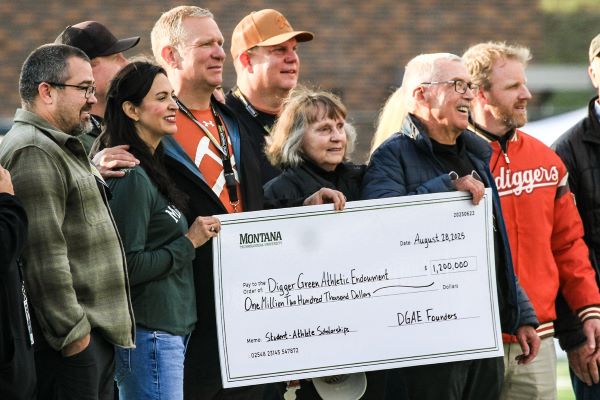 !A group stands together at the check presentation