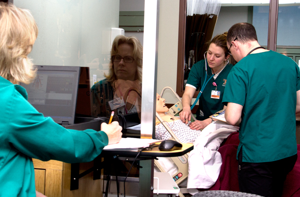 Nursing professor monitoring students in St. James Simulation Lab at Montana Tech