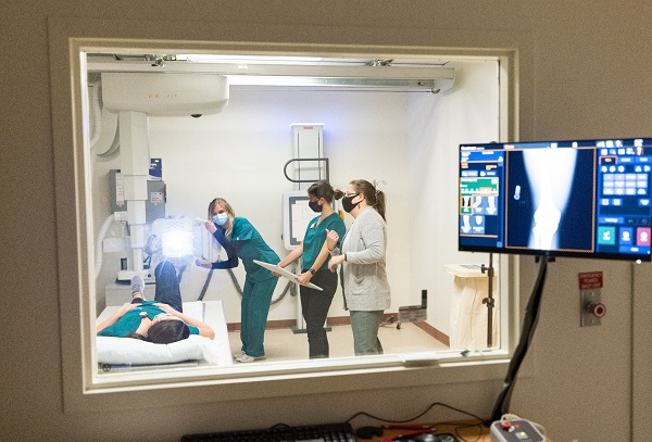 student practicing medical imaging procedures in a lab.